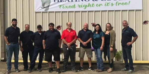 Ten professional staff members from Southern Air Cooling, Heating & Electrical standing together in front of company building.