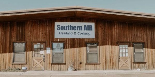 Wooden storefront building with Southern AIR Heating & Cooling signage displayed on the facade.